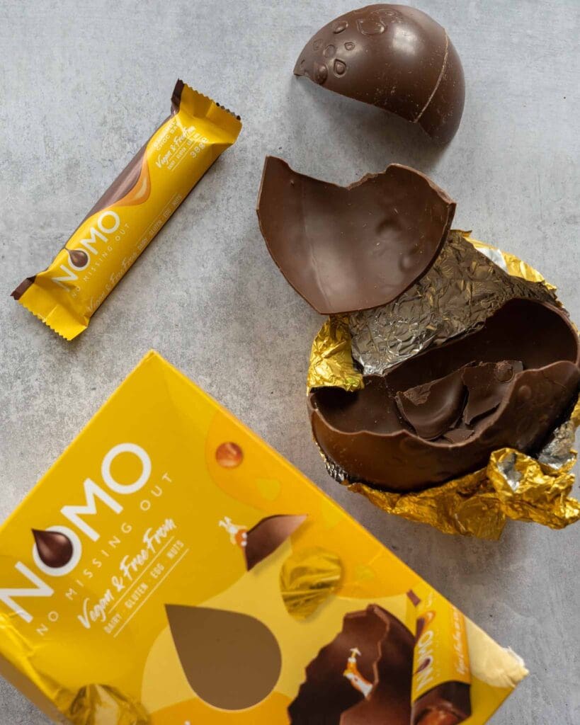 Nomo Caramel Easter egg broken open on a table top