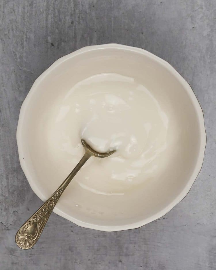 Icing in a bowl ready to top Christmas cookies