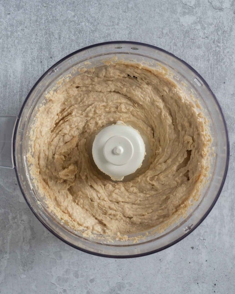 Freshly blended white bean hummus in a blender bowl