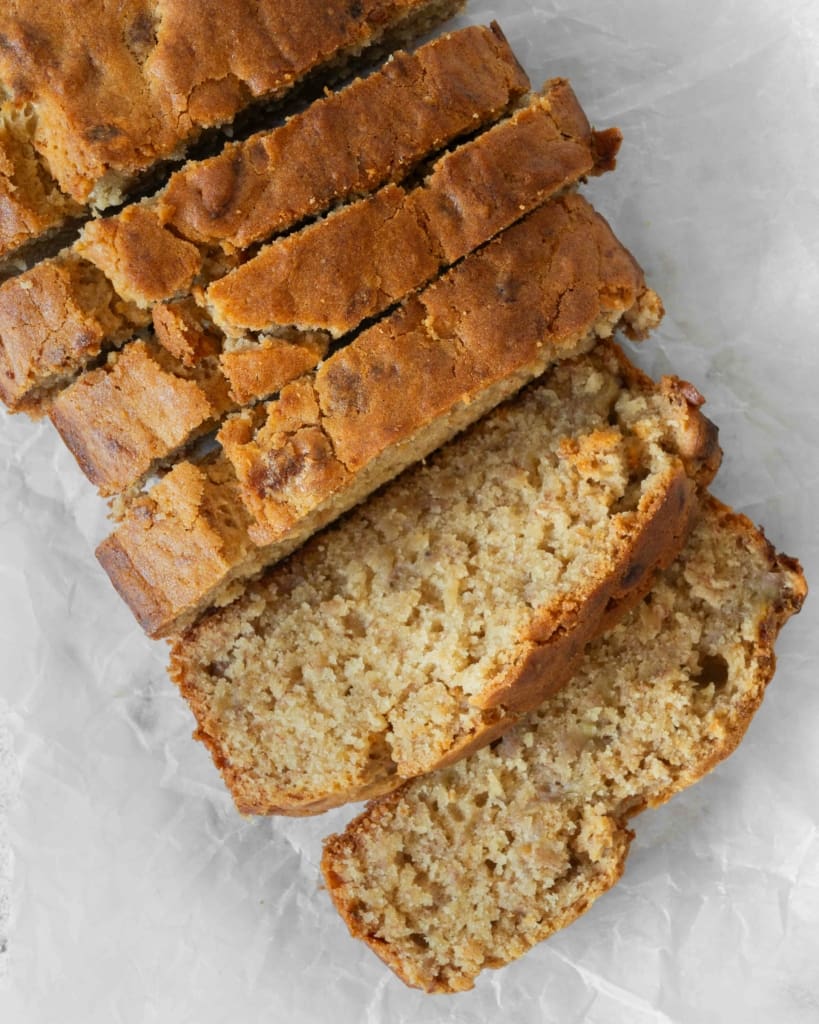 Slices of tender 5 ingredient vegan banana bread, with a golden top and a moist centre