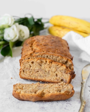 Slices of tender vegan banana bread, with a golden top and a moist centre
