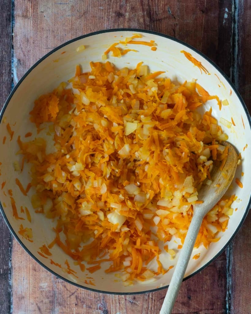 Partially cooked vegetables in a frying pan, making the base of a vegan bolognese