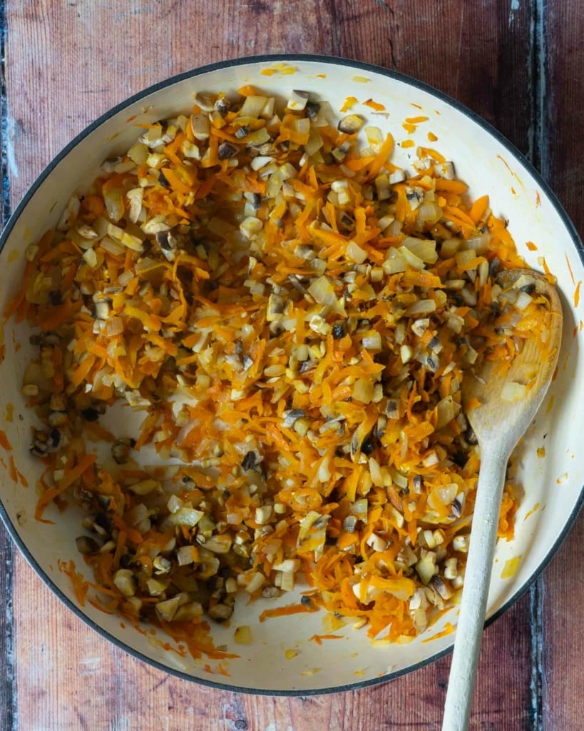 Fried vegetables in a pan, making the base of a vegan bolognese