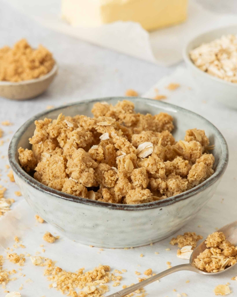 A close up photograph of freshly mixed oatmeal streusel-style crumble topping.