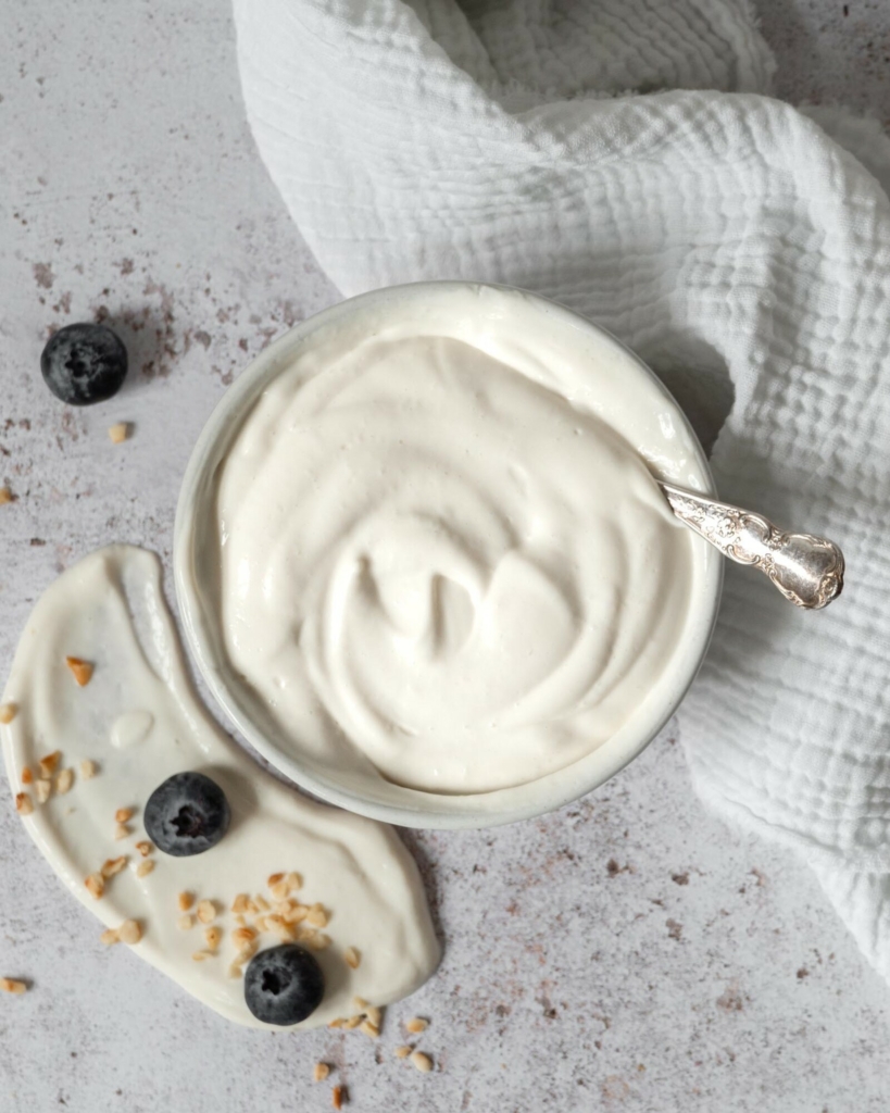 A bowl of creamy vegan mascarpone on a table top
