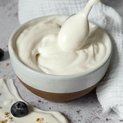A bowl of vegan mascarpone being stirred