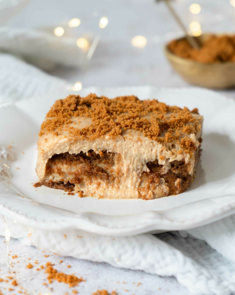 A plate of Biscoff tiramisu with layers of cinnamon lotus biscuits, creamy mascarpone and crumbled biscuit on top