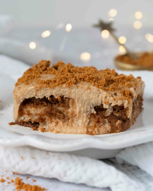 A plate of Biscoff tiramisu with layers of cinnamon lotus biscuits, creamy mascarpone and crumbled biscuit on top