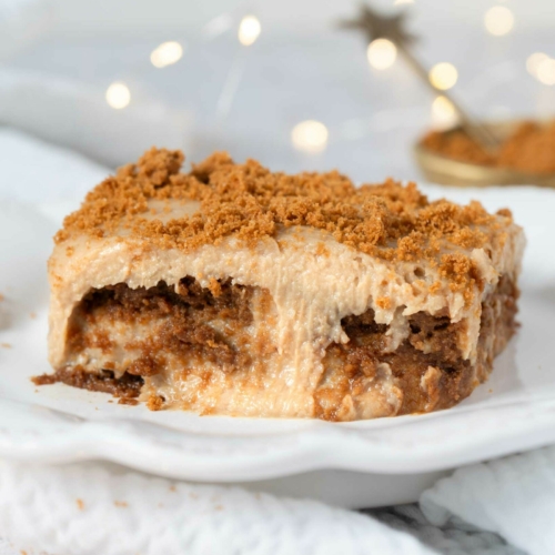 A plate of Biscoff tiramisu with layers of cinnamon lotus biscuits, creamy mascarpone and crumbled biscuit on top