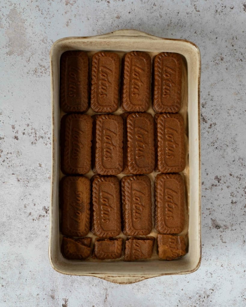 A layer of biscoff biscuits on top of vegan mascarpone