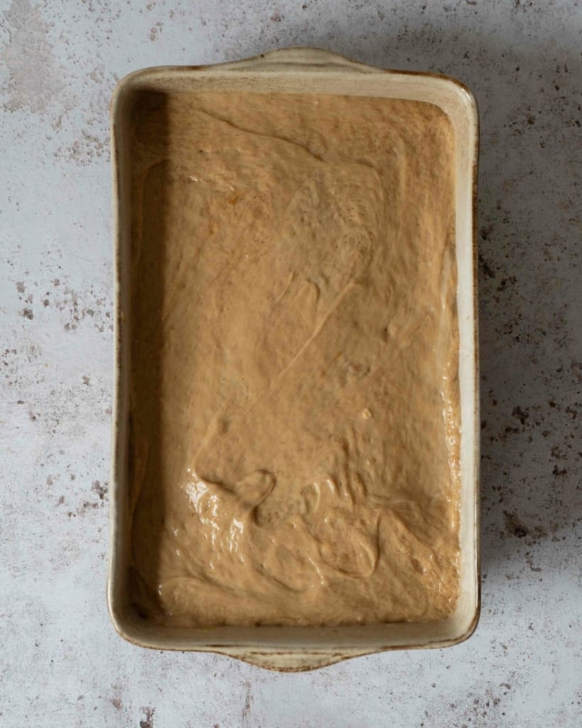 Making a vegan Biscoff tiramisu recipe, with the final layer of vegan mascarpone added to the top