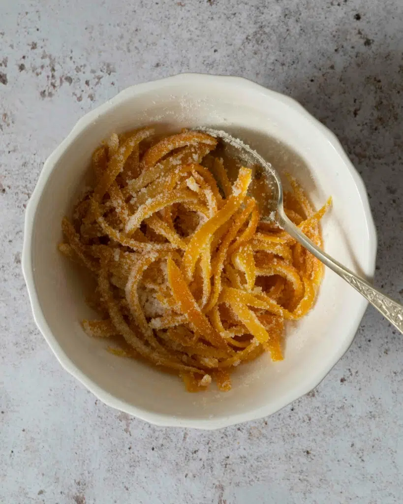 Candied orange peel in a bowl, coated in sugar