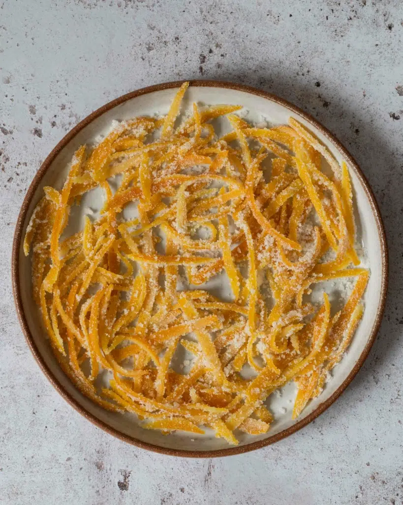 Candied orange peel spread out on a plate