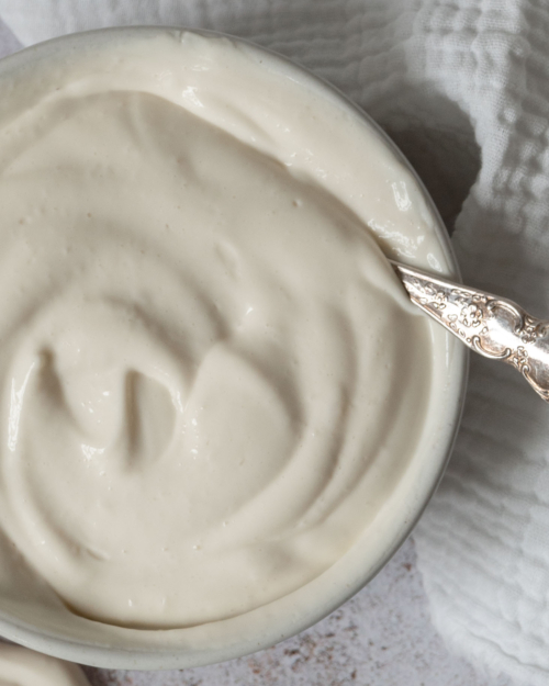 A close up photo of a bowl of thick and creamy vegan mascarpone