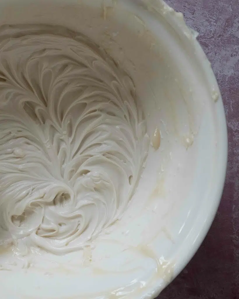Making a whipped vegan fruit dip recipe, with the creamy whipped dip in a large mixing bowl