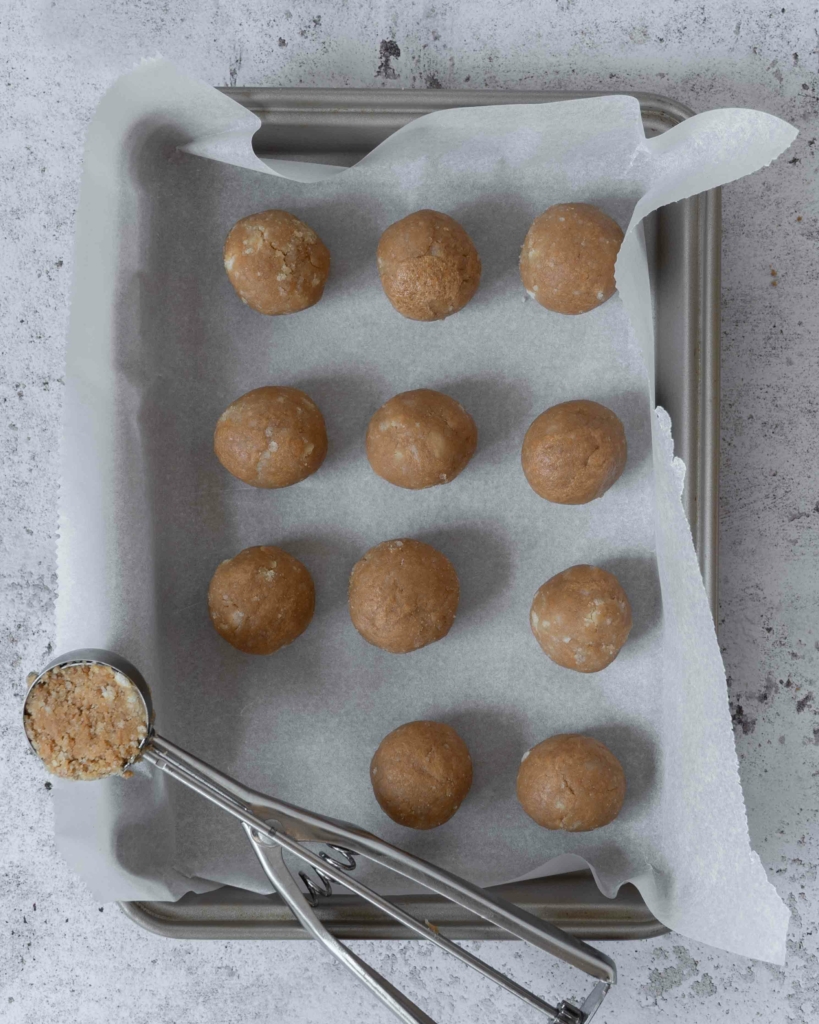 Balls of cake pop mixture on a lined tray