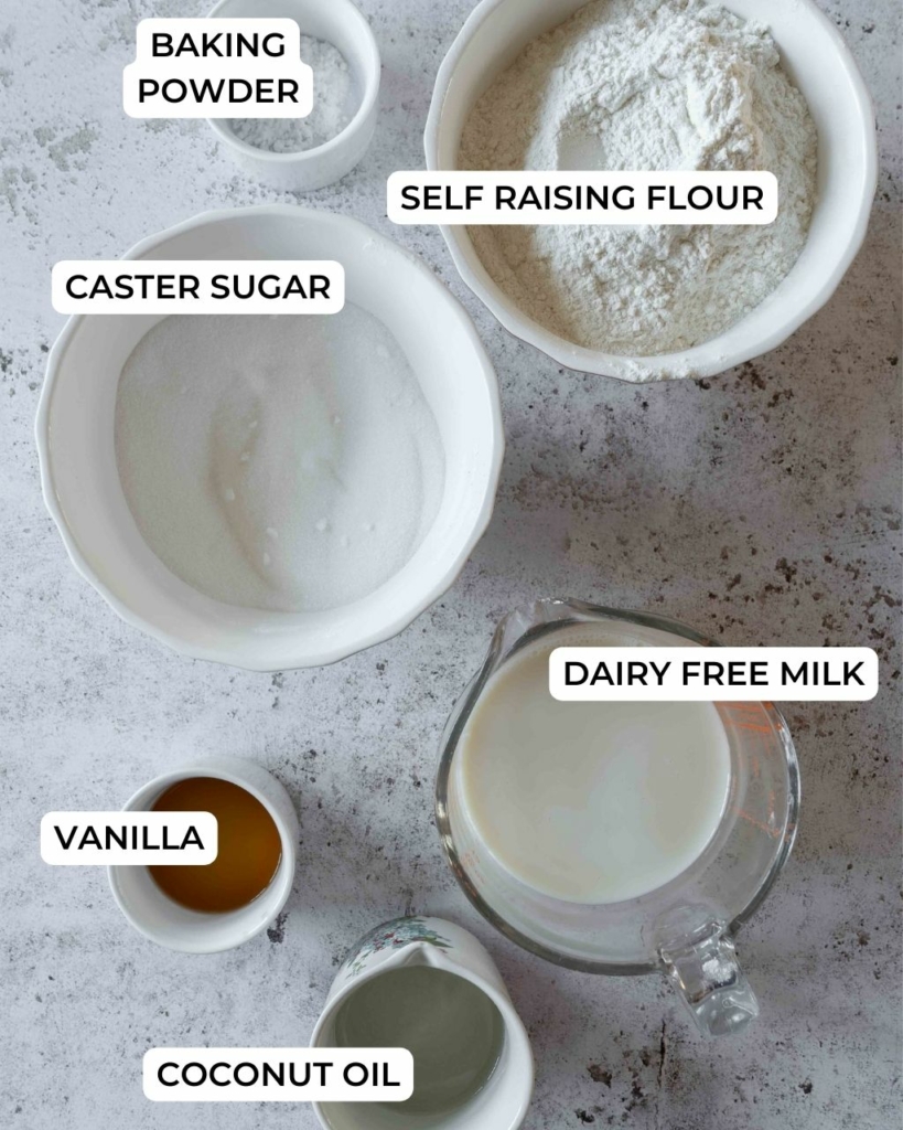 The ingredients to make a vegan vanilla sponge cake laid out on a table.