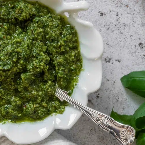 A close up of vibrant green pesto without pine nuts.