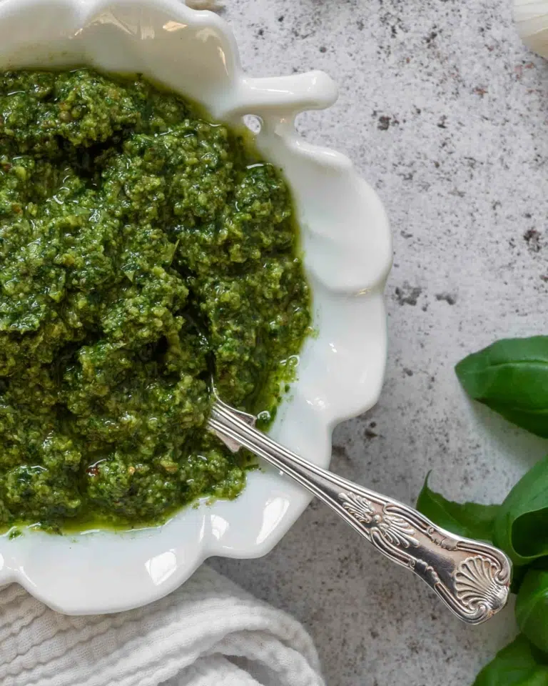 A close up of vibrant green pesto without pine nuts.