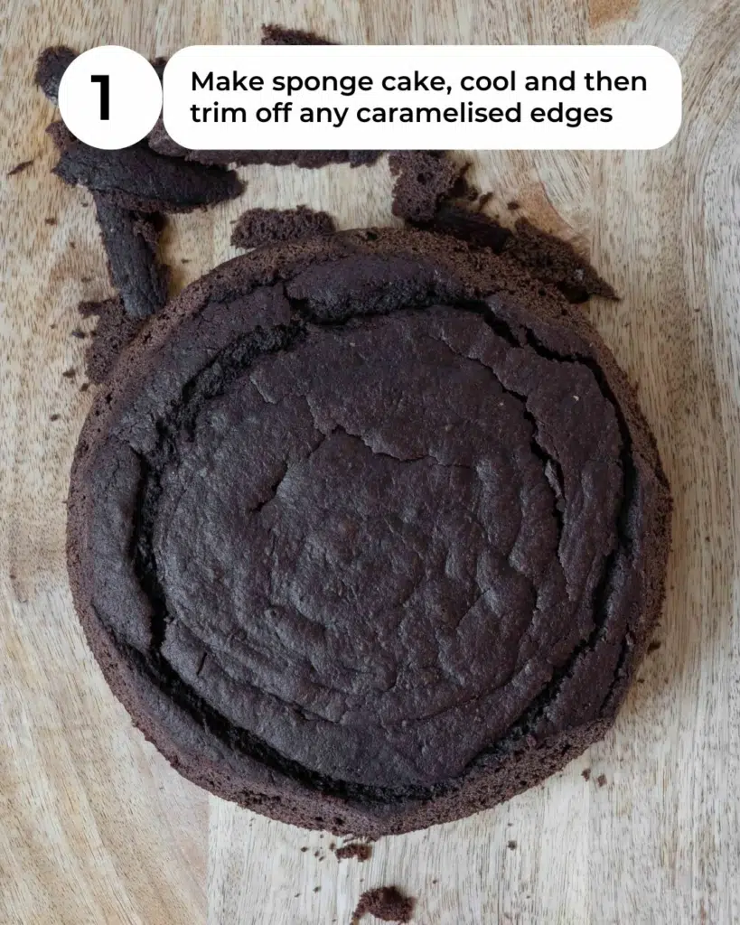 A chocolate cake on a chopping board, with the edges trimmed off.