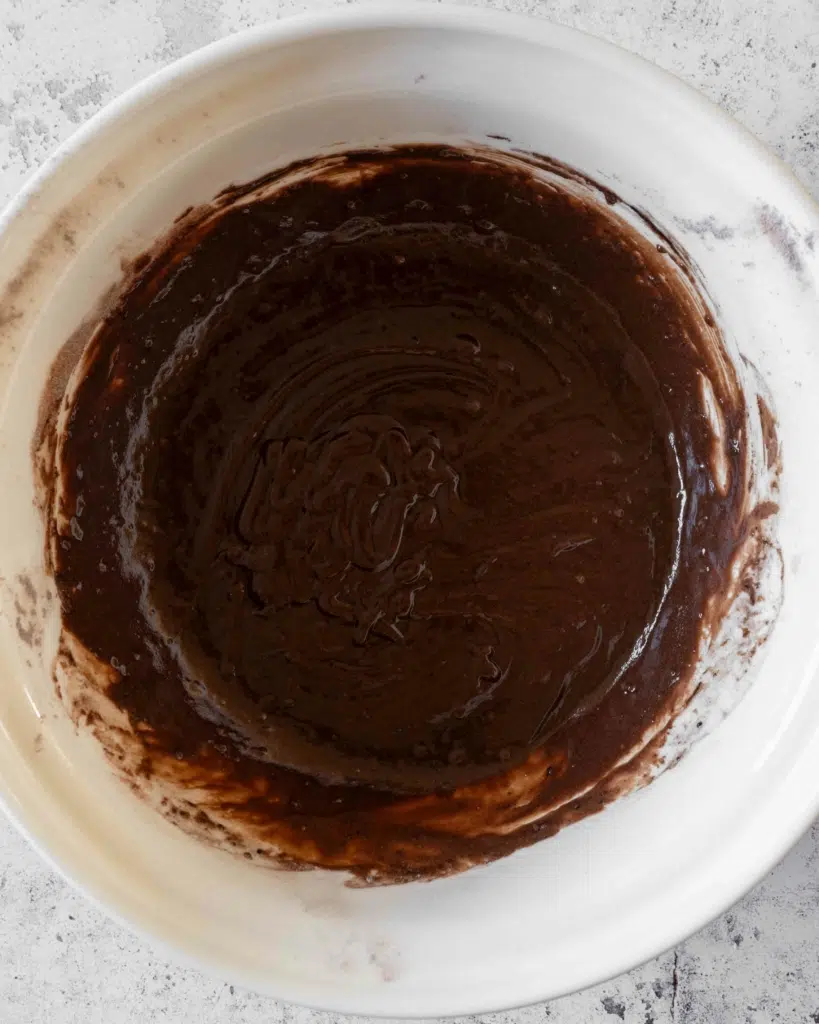 A large mixing bowl filled with vegan chocolate cake batter