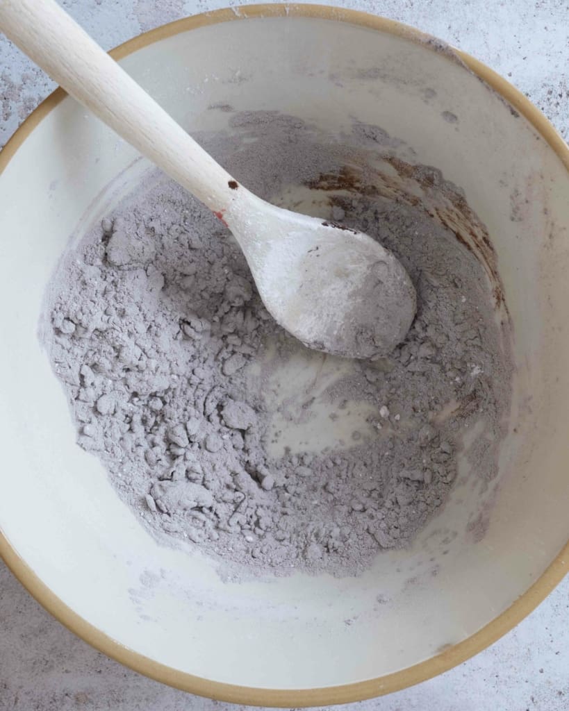 The ingredients for making chocolate frosting in a large mixing bowl.