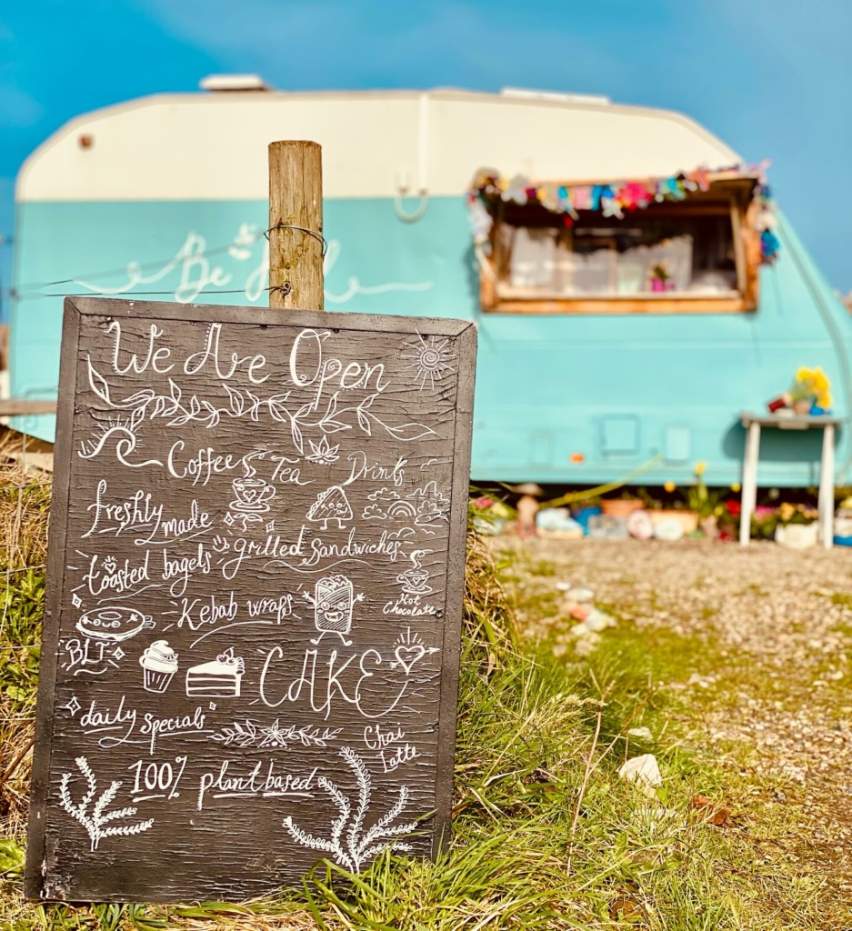 A cute blue caravan selling vegan coffee and food in Hayle, Cornwall
