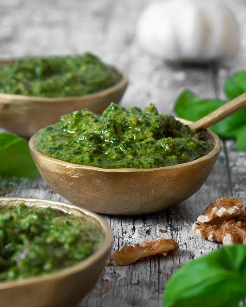 Close up of a small bowl of vegan basil walnut pesto