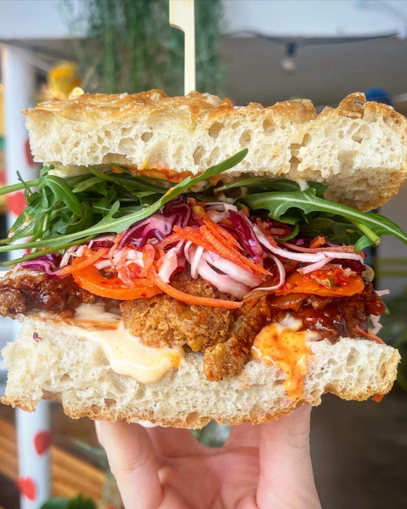 A colourful vegan sandwich on focaccia bread