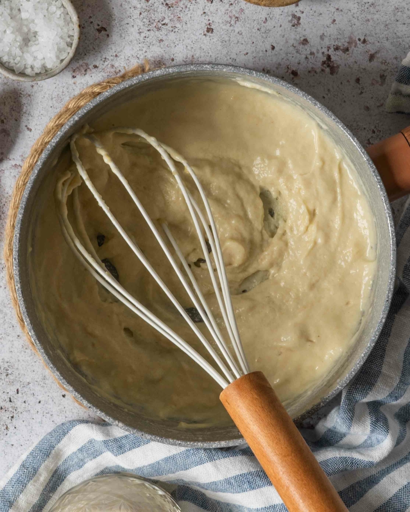 A thick white paste in a saucepan; vegan white sauce in the making