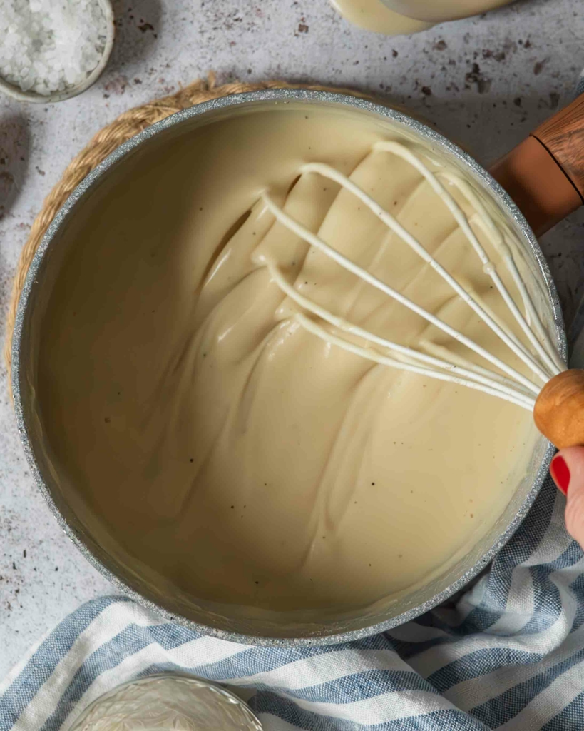 Vegan bechamel sauce with oat milk, being whisked