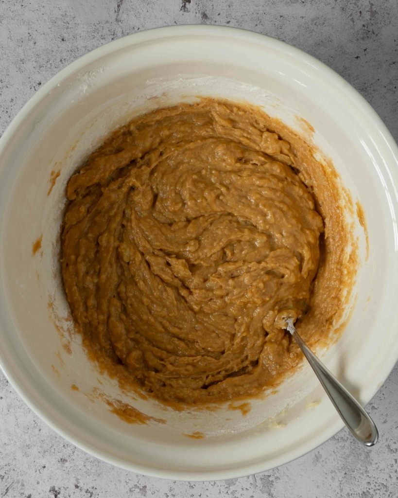 Vegan pumpkin banana bread batter in a large mixing bowl.