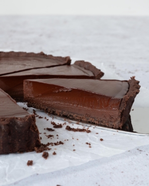 A piece of French Chocolate tart on a cake slice