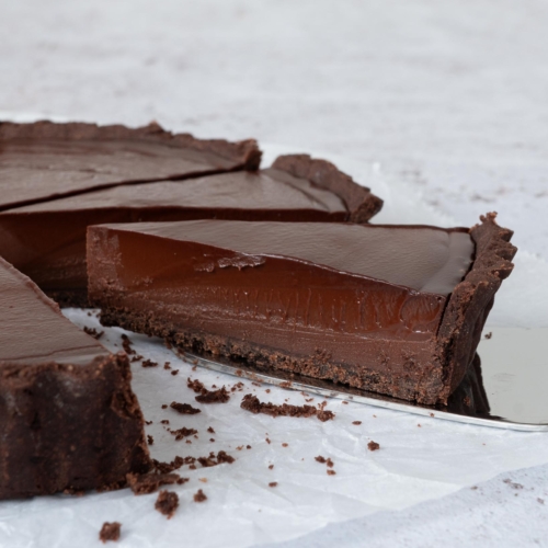 A piece of French Chocolate tart on a cake slice