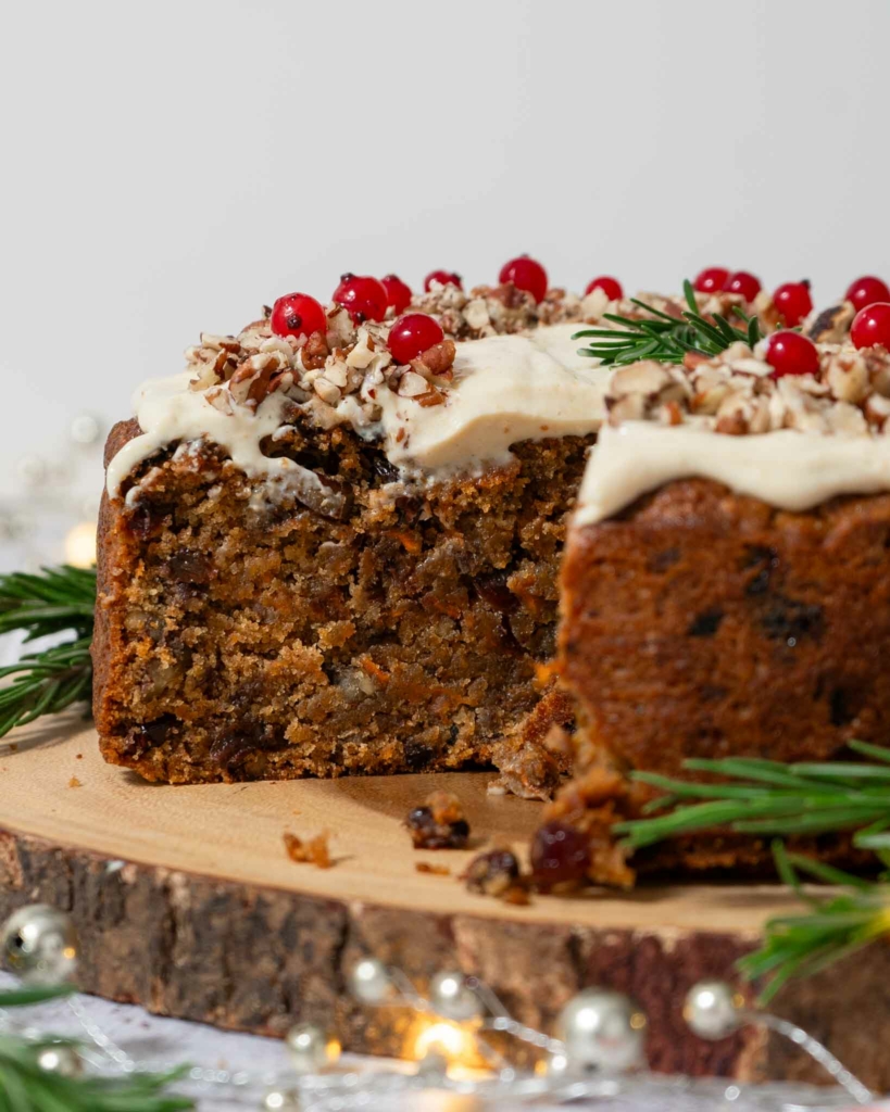 A festive carrot cake cut open to reveal the moist interior