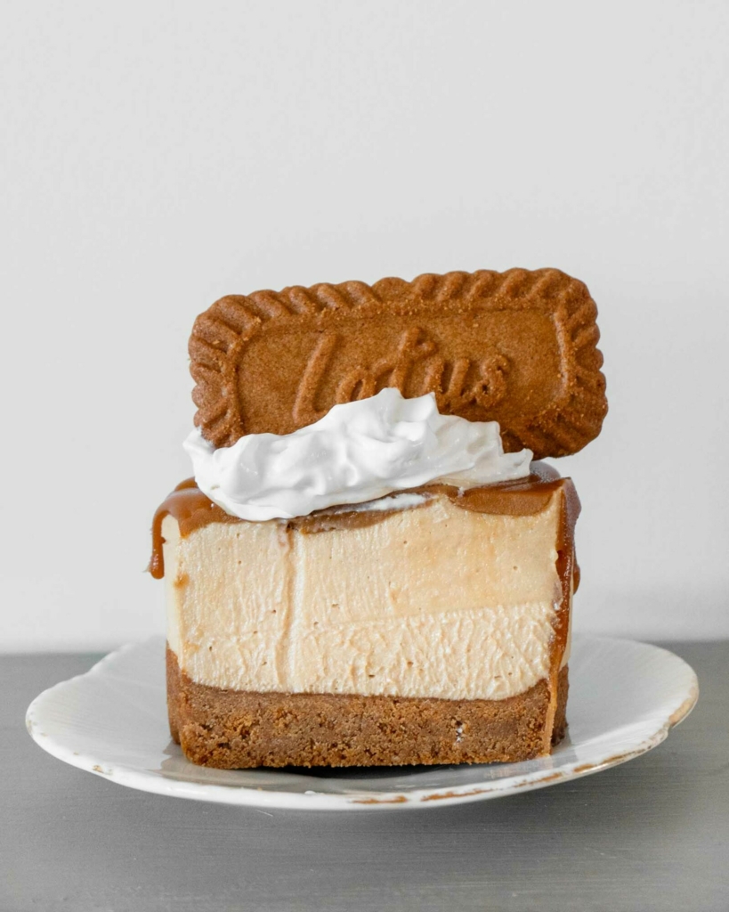 A Biscoff mini cheesecake cut in half to reveal the creamy texture inside