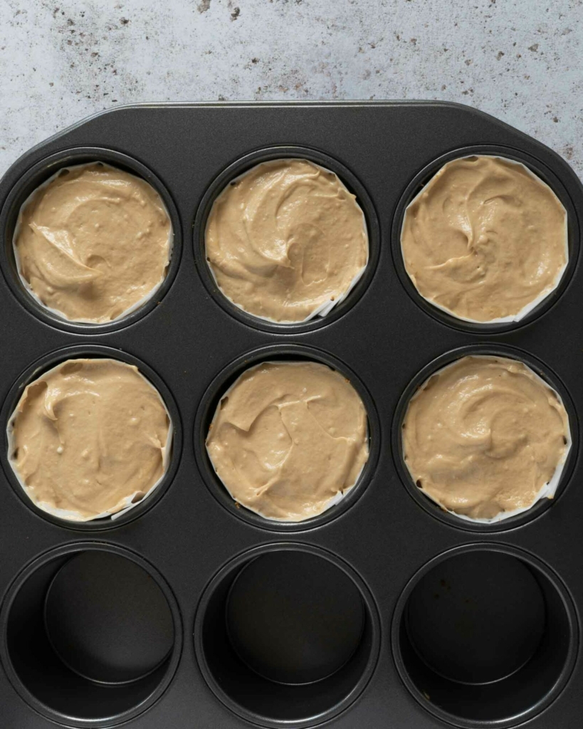 Individual no bake Biscoff mini cheesecakes in a deep muffin pan