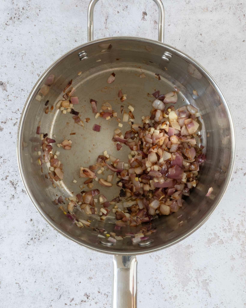 Fried red onion and garlic in a large saucepan