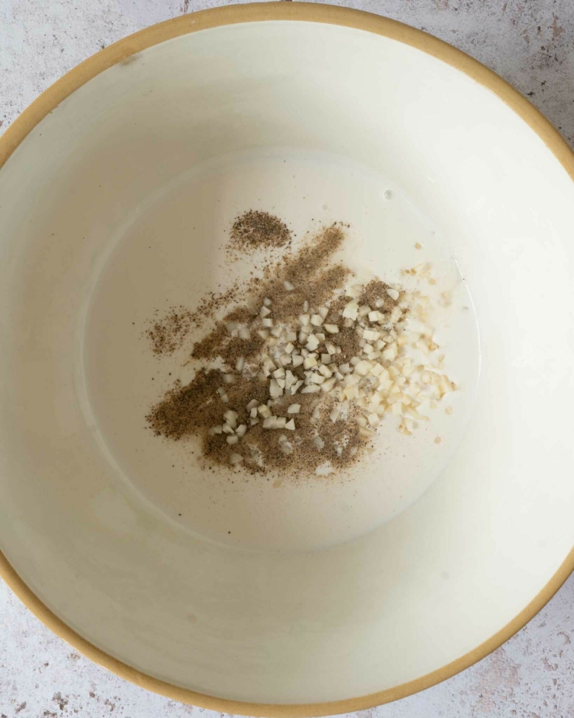 Cream and seasoning in a large bowl