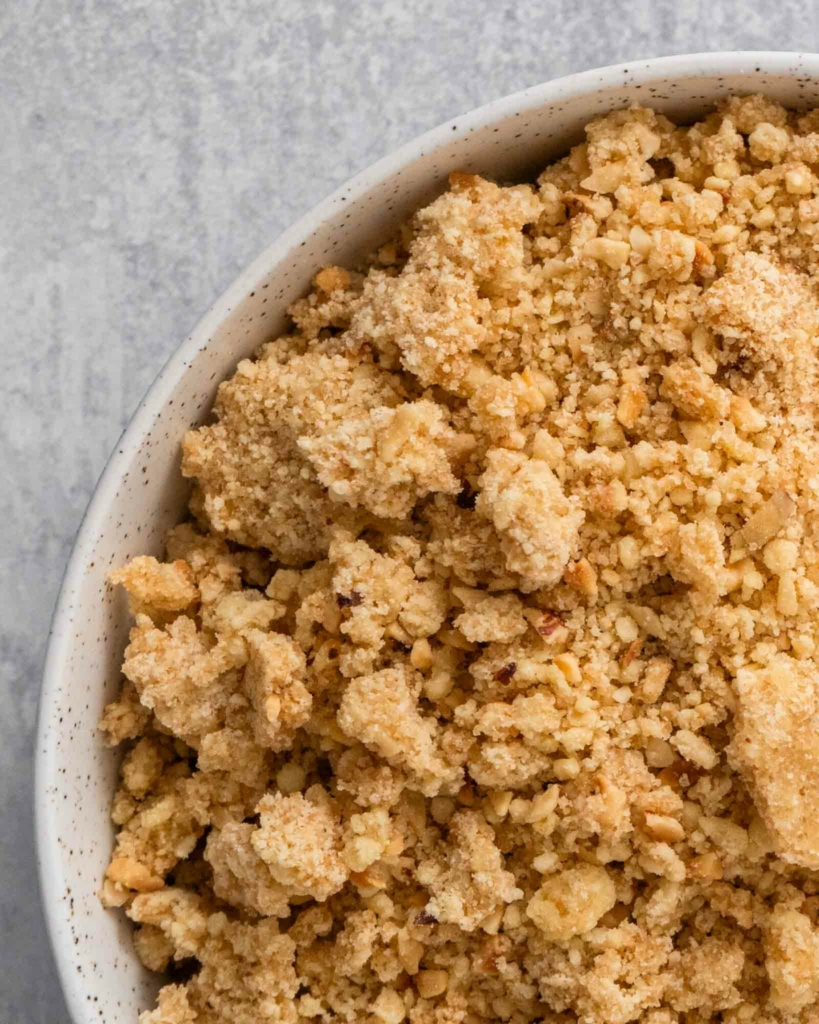 Freshly cooked hazelnut crumble topping in a bowl