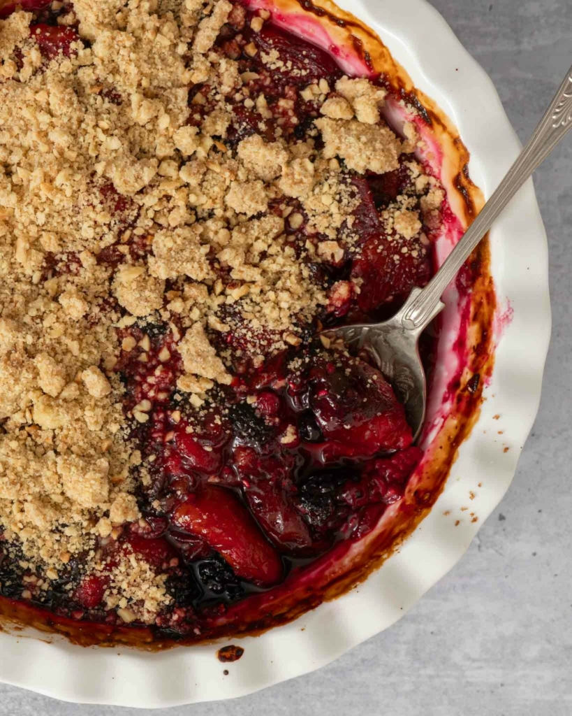 A bright red berry crumble topped with hazelnut crumble topping