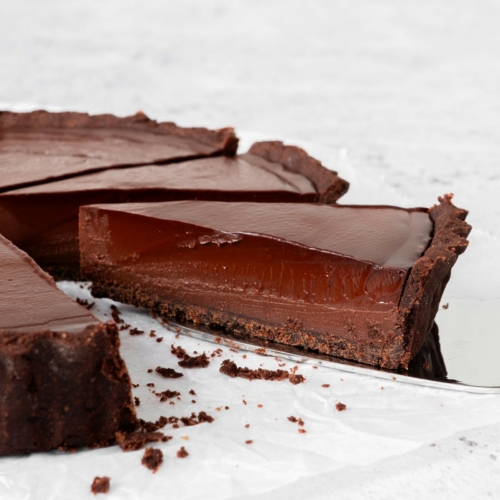 A piece of French Chocolate tart on a cake slice