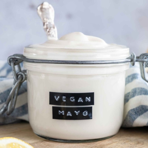 A glass jar with vegan mayonnaise in it