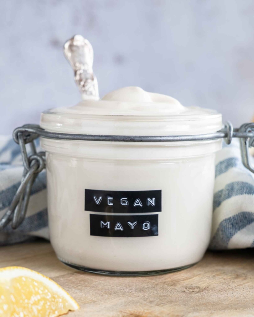 A glass jar with vegan mayonnaise in it