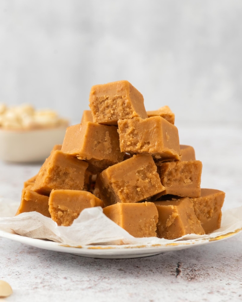 A plate stacked high with 3 ingredient peanut butter fudge