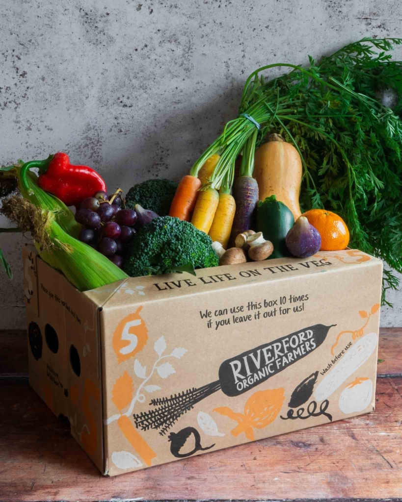 A Riverford box bursting with fresh fruit and vegetables