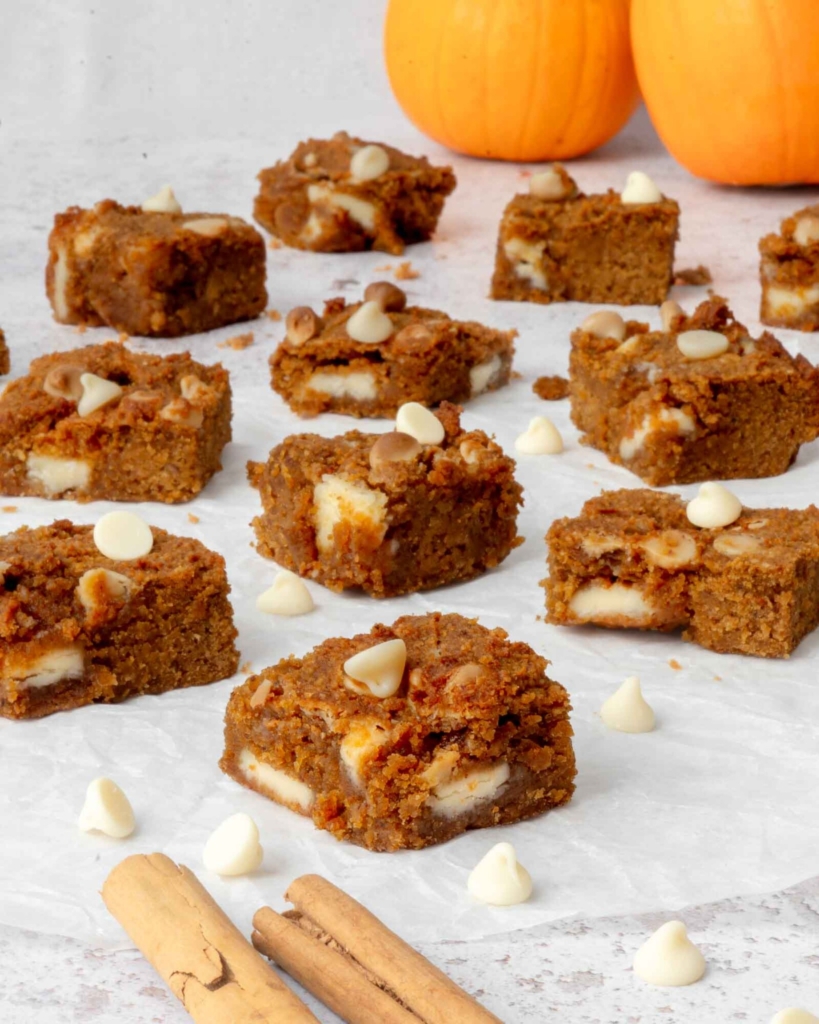 Little squares of pumpkin chickpea blondies, studded with white chocolate chunks