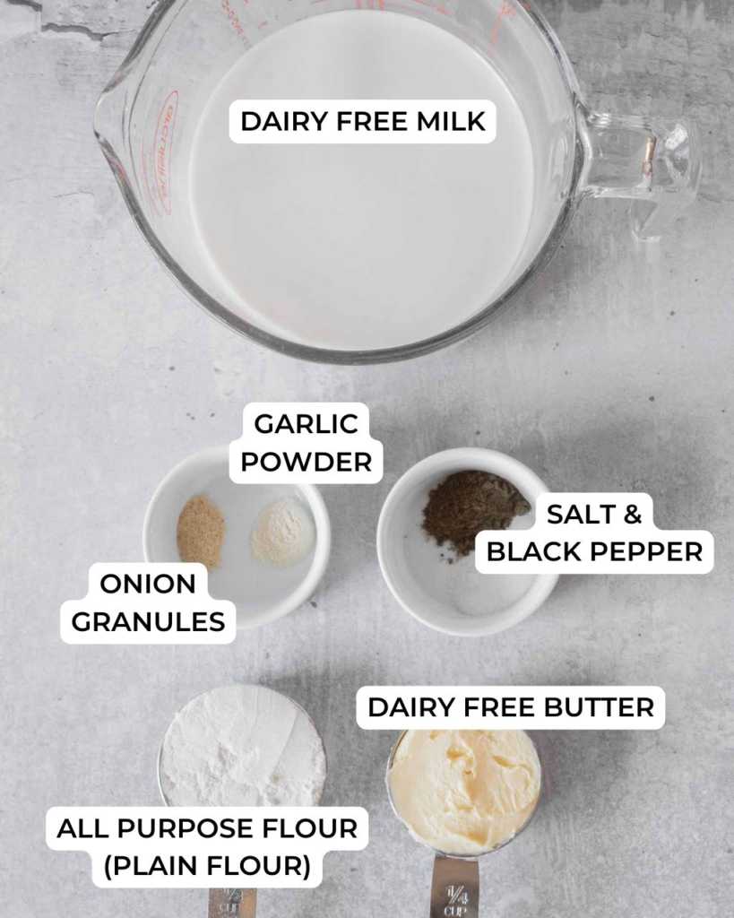 The ingredients needed to make a white gravy recipe without milk laid out on a table top