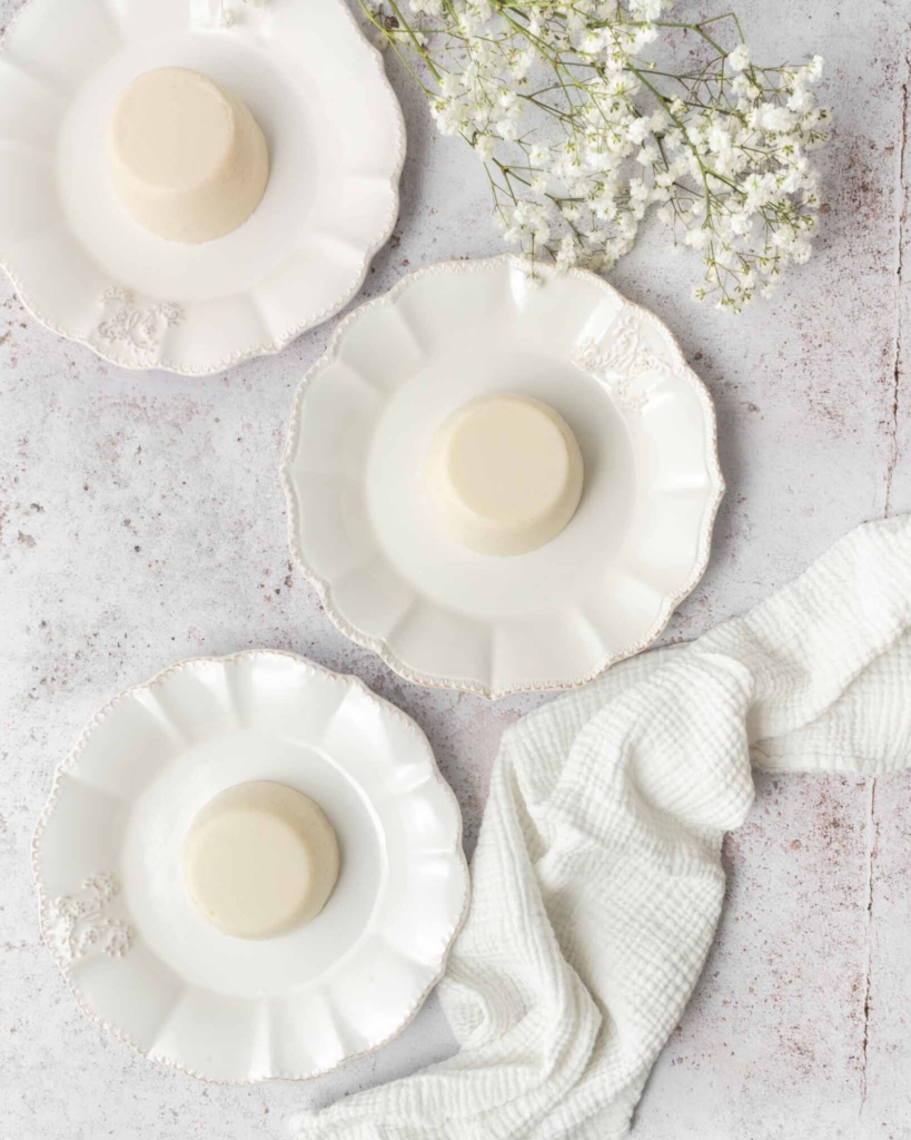 Three vanilla panna cotta without gelatin on white plates