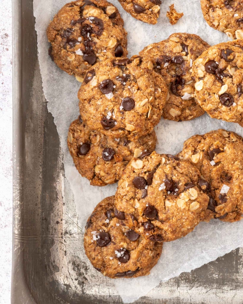 A tray of freshly cooked dairy free oatmeal cookies, studded with chocolate chips